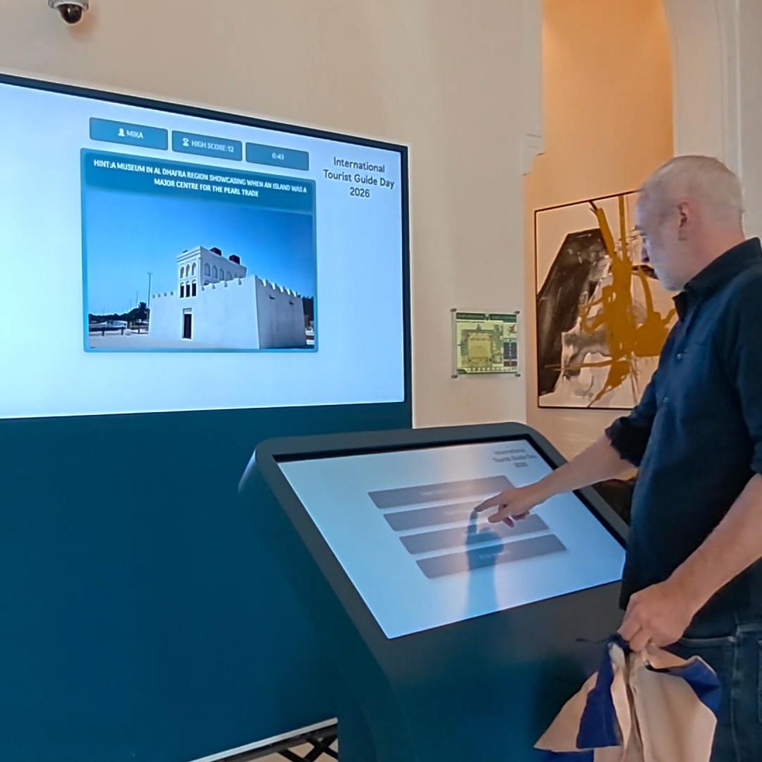 Multi-screen interactive UAE landmark guessing game display with custom branded interface for immersive event activation and digital tourism engagement.
